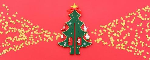 Christmas red decorations, fir tree branches on red background photo