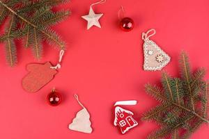 Christmas red decorations, fir tree branches on red background photo