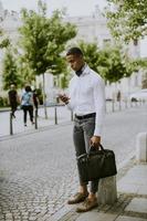 Young African American businessman using a mobile phone photo