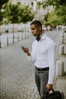 Young African American businessman using a mobile phone photo