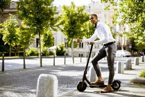 Young African American using electric scooter on a street photo