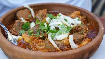 Abkhazian salted beef stew in clay dishes photo