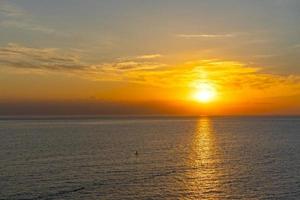 Colorful bright sunset on the background of the seascape photo