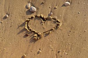 Sandy beach with a painted heart photo