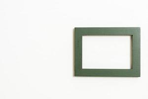 Empty picture frame on white wall background with copy space photo