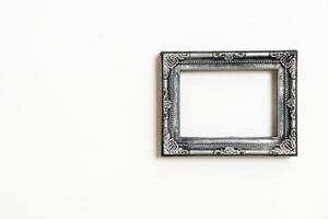 Empty picture frame on white wall background with copy space photo