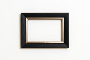 Empty picture frame on white wall background with copy space photo