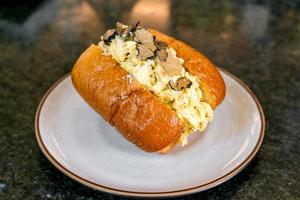 Bun or bread with scrambled eggs and truffle mushroom photo