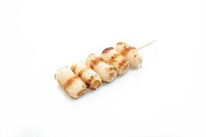 Grilled tube-shaped fish paste cake skewer isolated on white background photo