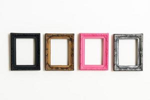 Empty picture frame on white wall background with copy space