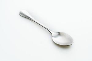 Silver spoon isolated on white background photo