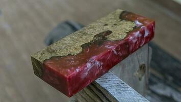 Casting epoxy resin maple burl wood on the table photo