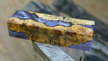 Casting epoxy resin maple burl wood on the table photo