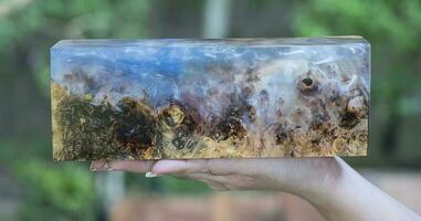 Casting epoxy resin maple burl wood on the table photo