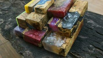 Casting epoxy resin maple burl wood on the table photo