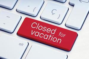 Closed for vacation phrase on computer Keyboard Key photo