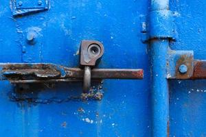 Old rusty lock on the bright blue door photo