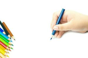 Women hand with pencil by hand on  white  paper at white background photo