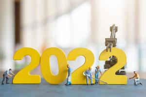 Miniature people worker team build number 2022