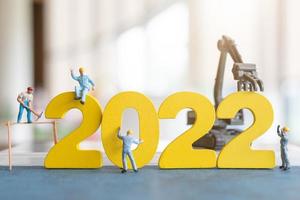 Miniature people worker team build number 2022