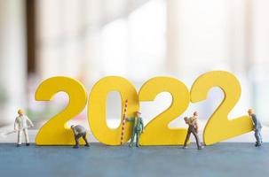 Miniature people worker team build number 2022 photo
