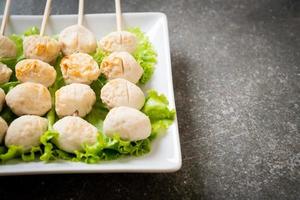 Grilled pork meatballs with sweet chili sauce on plate photo