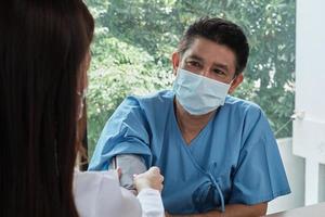 Doctor checks the health of handicapped man. photo