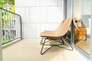 Empty outdoor patio chair on balcony photo