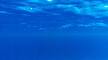 Underwater of tropical sun rays passing through water. photo