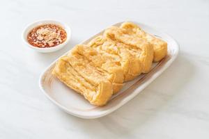 Fried tofu with sauce - vegan and vegetarian food style photo