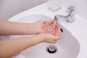 Hand Washing in Washbasin photo