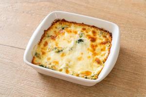 Baked spinach lasagna with cheese in white plate photo