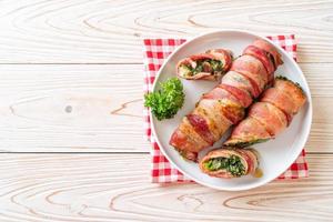 Baked bacon roll stuffed spinach and cheese photo