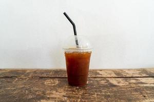 Iced Americano black coffee glass in coffee shop photo