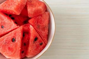 Fresh watermelon sliced in white bowl photo