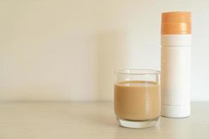 Coffee latte glass with ready to drink coffee bottles on the table photo