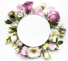 Pink flowers in round frame with white circle for text photo