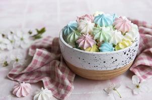 Small colorful meringues in the  ceramic bowl photo