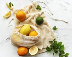 Juicy ripe citrus fruits in an eco-friendly shopping bags