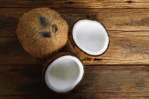 Fresh coconuts on old wooden background, Food top view photo