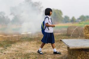 Asian student in uniform studying at countryside of Thailand photo