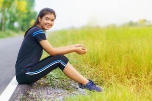 Portrait of beautiful girl in sportswear smiling during exercise photo