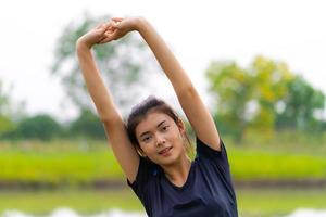 Portrait of beautiful girl in sportswear smiling during exercise photo