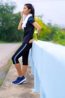 Portrait of beautiful girl in sportswear smiling during exercise photo