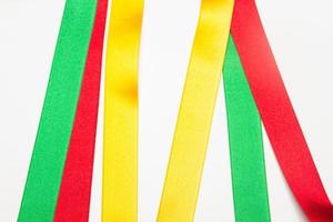 Coloured fabrics and ribbons, basic colours on a white background photo