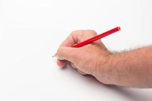 Coloured pencil in hand on white background photo