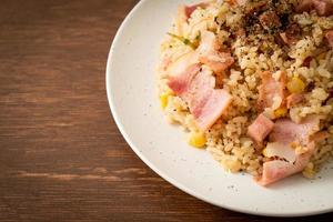 Fried rice with bacon, ham, and black peppers on white plate photo