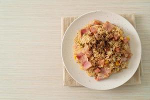 Fried rice with bacon, ham, and black peppers on white plate photo