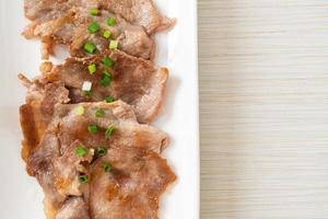 Grilled pork neck sliced on plate in Asian style photo