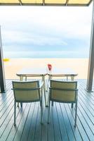 Empty dining table in restaurant with sea beach background